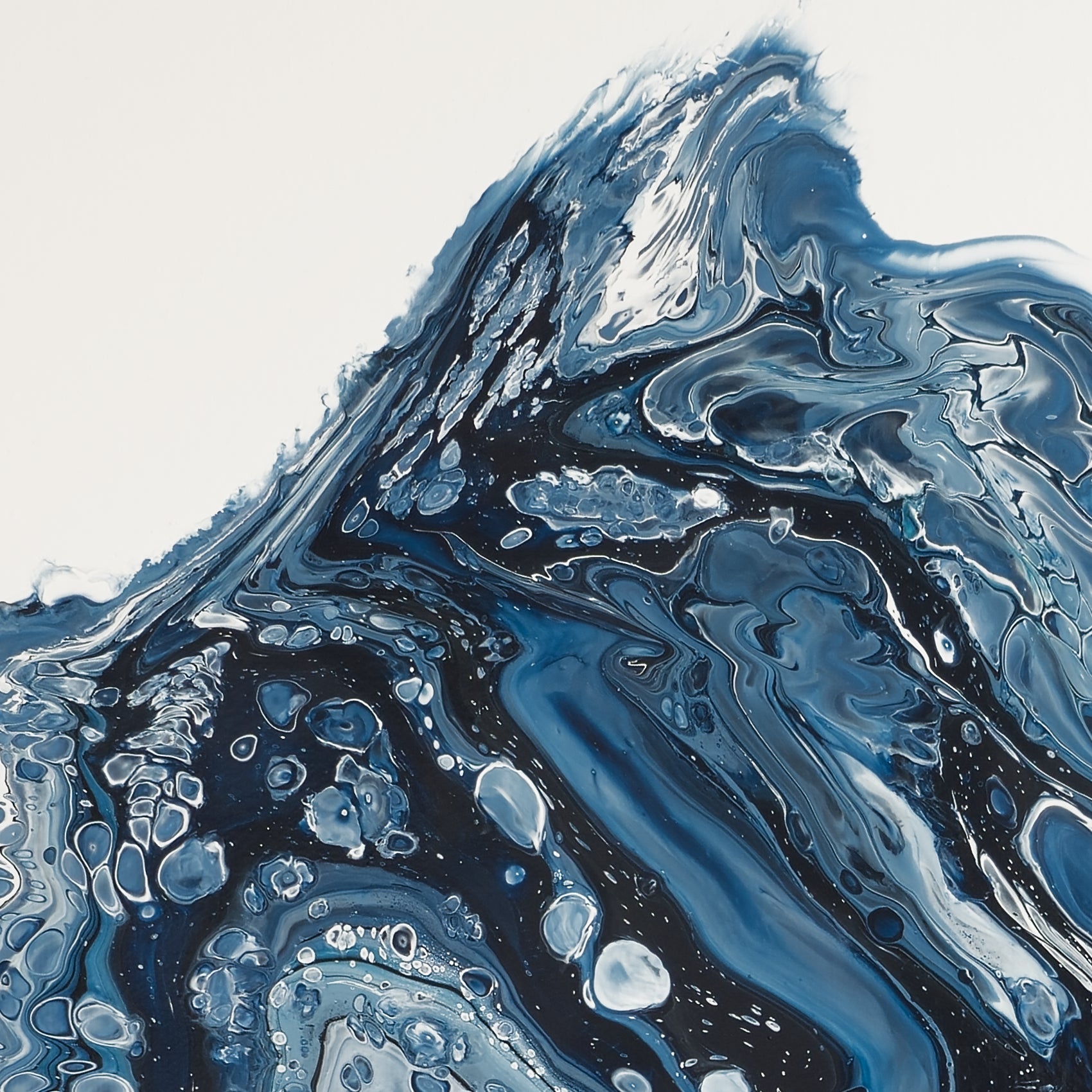 Close-up of square abstract acrylic painting in inky navy and white, a mass of ice breaking and churning into cold sea, glacier calving.