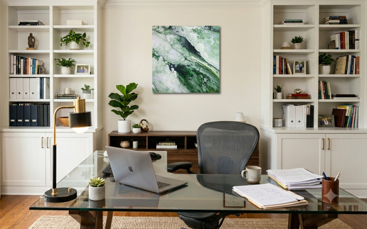 Square abstract acrylic painting in soft forest greens and pale light, fluid poured marbled texture, calm woodland mood displayed in a study.