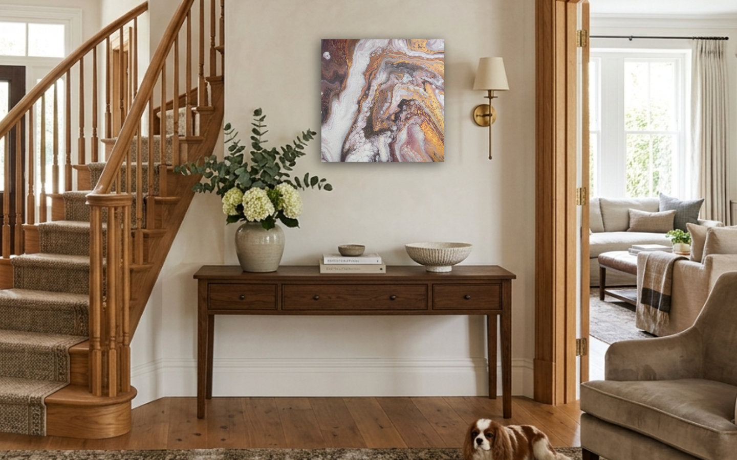 Square abstract acrylic painting in warm gold, bronze and earth browns with white, layered geological marbled texture displayed in entryway