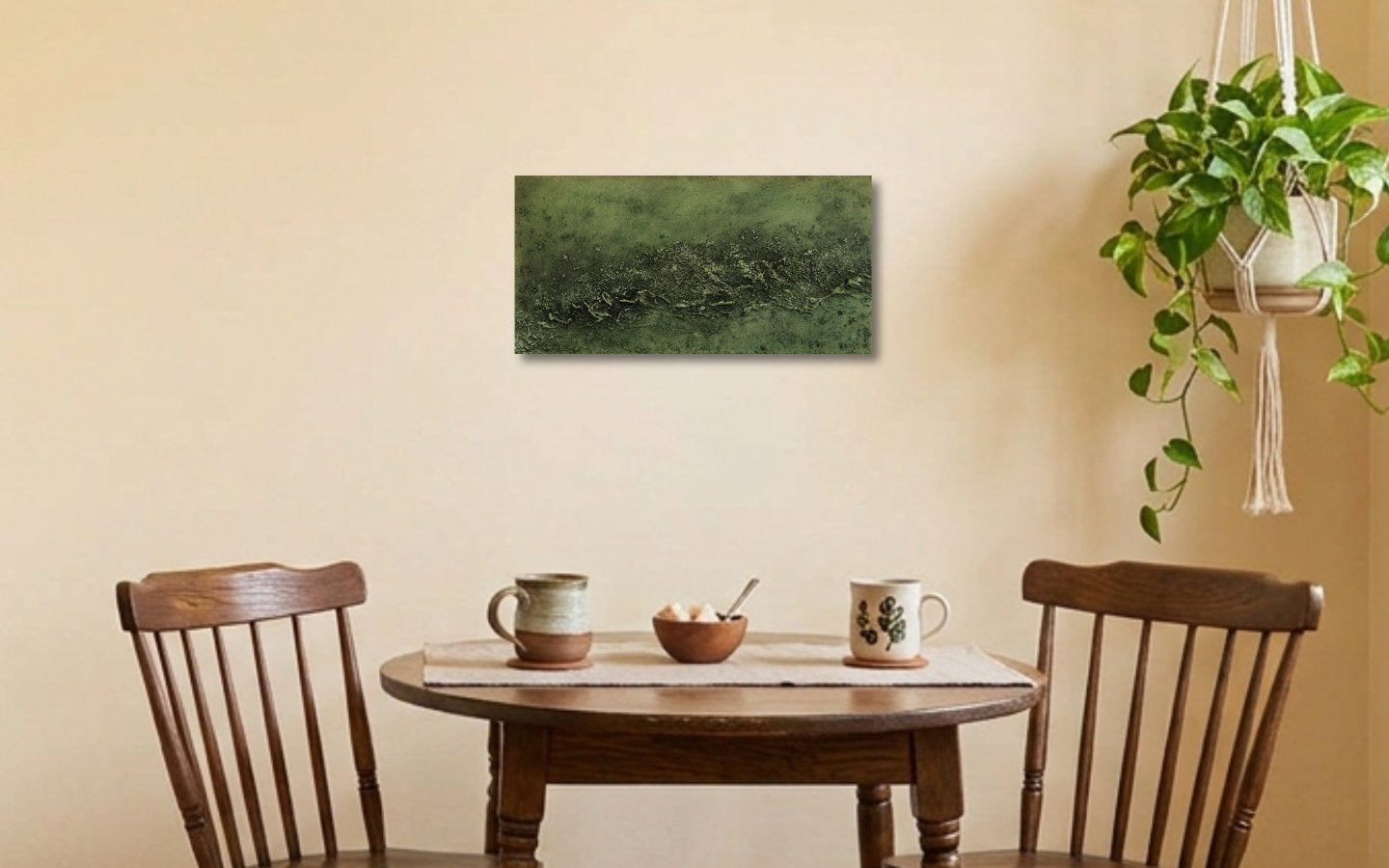 Landscape textured abstract acrylic painting in muted olive and sage green with a raised crusted ridge, land seen from high above displayed in a coffee corner
