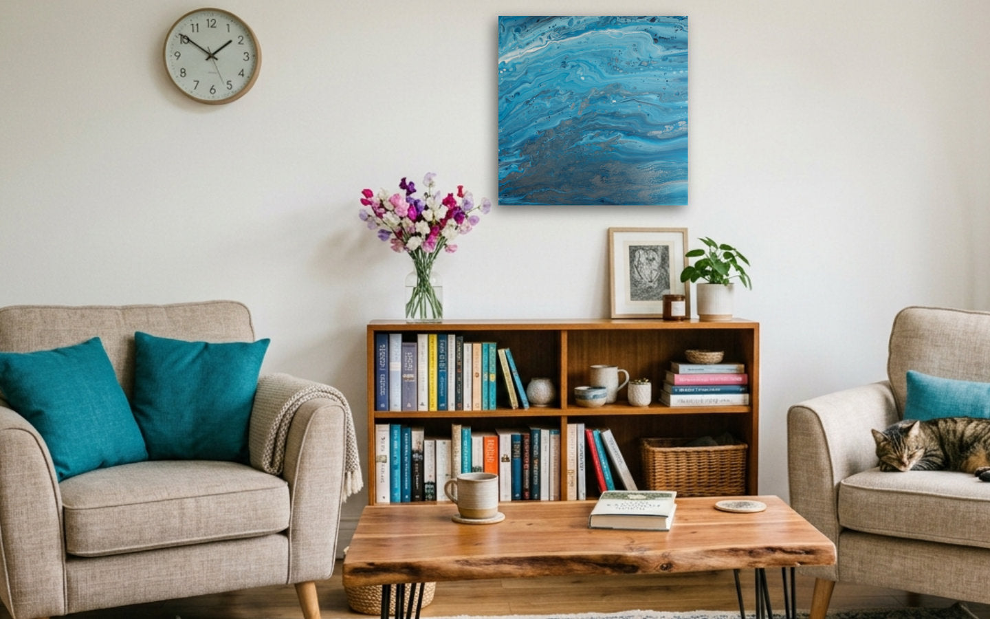 Square abstract acrylic painting in bright blue over stony pewter tones, clear shallow coastal water showing rock and sand below displayed in a living room.